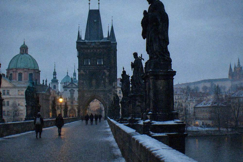 The Old Town Bridge Tower seen from the bridge deck with statues in the foreground