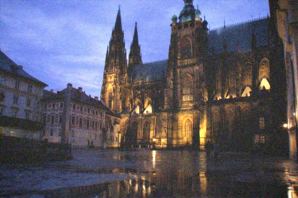 Gothic facade and towers of St Vitus Cathedral seen from a castle courtyard