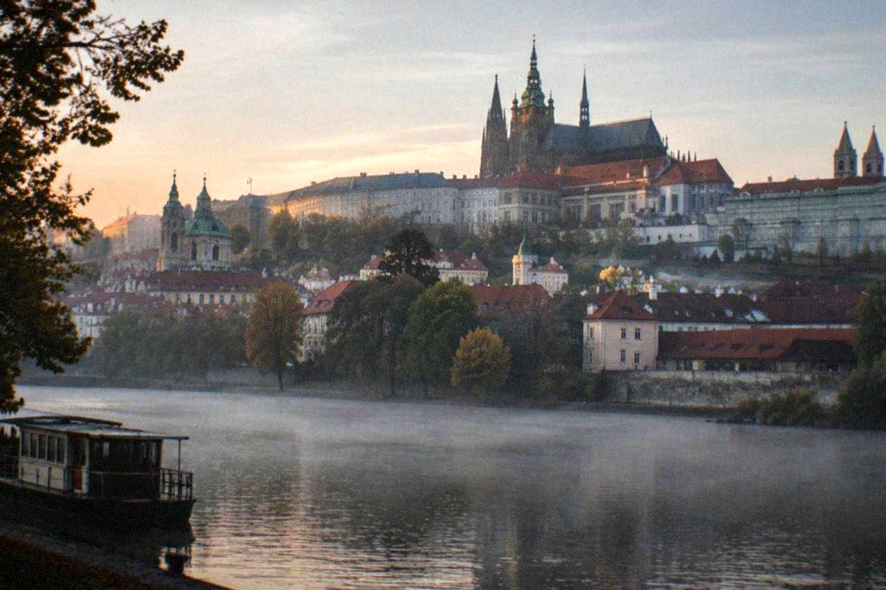Prague Castle complex with St Vitus Cathedral towers above red rooftops