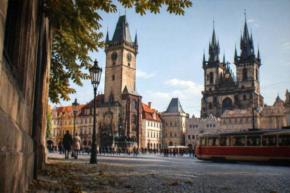 Old Town Square in Prague with the Old Town Hall tower rising above the rooftops