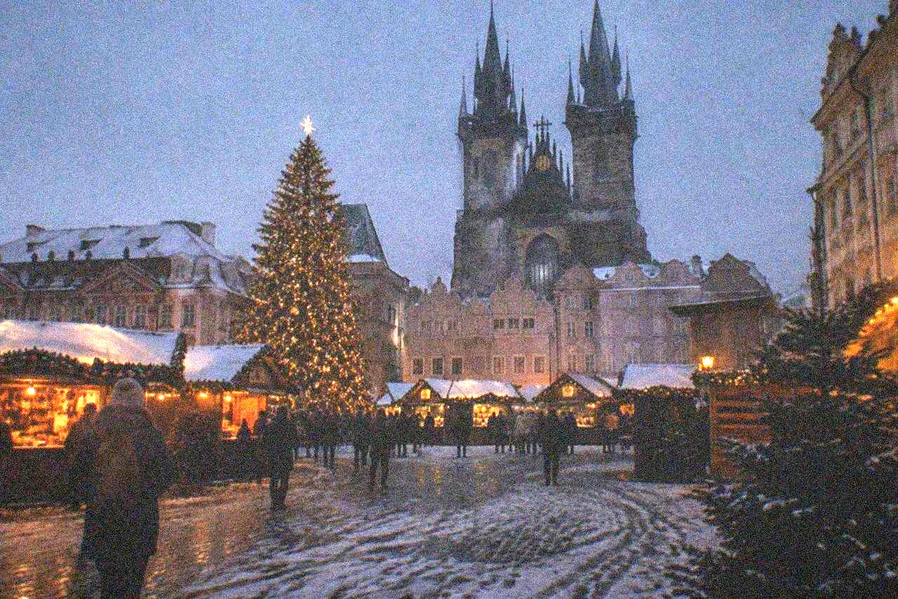 Old Town Square in Prague with a Christmas tree and market stalls in front of the Church of Our Lady before Týn