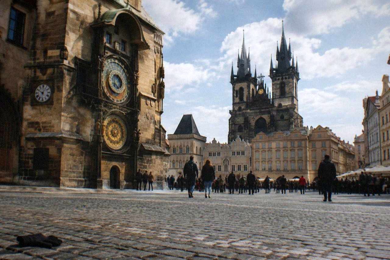 Crowded Old Town Square in Prague with the Astronomical Clock tower rising above the rooftops
