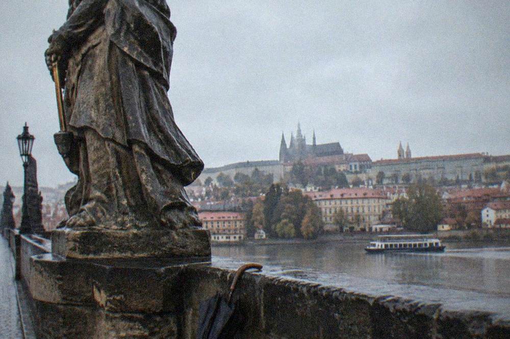 Baroque statue on the Charles Bridge balustrade against open sky