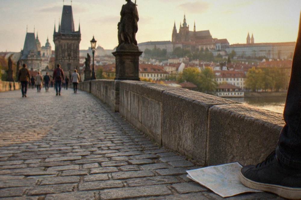 Charles Bridge crossing the Vltava with the bridge towers at each end in late afternoon light