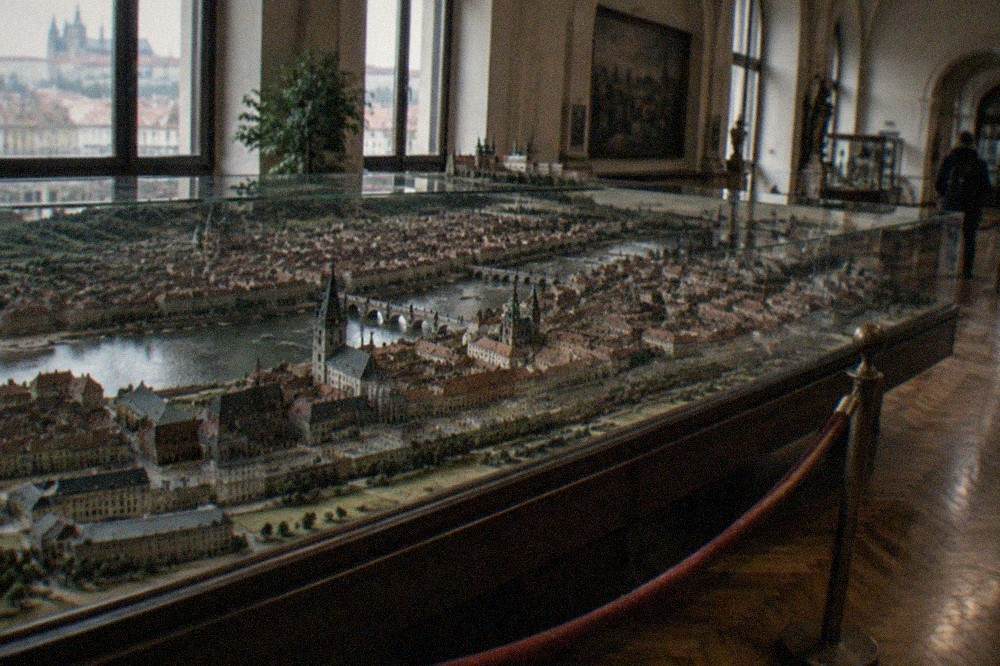 Grand museum hall with a large historic model of a city displayed under glass
