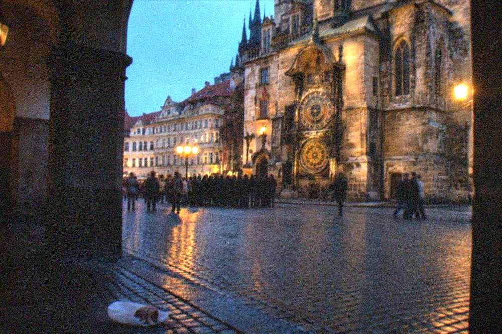 A tour group listening to a guide beside the Old Town Hall and Astronomical Clock on Old Town Square
