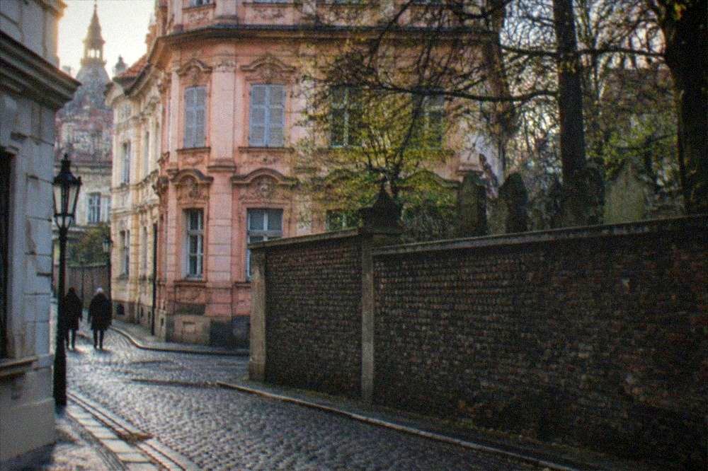 Cobblestone street corner in Josefov with ornate building facades