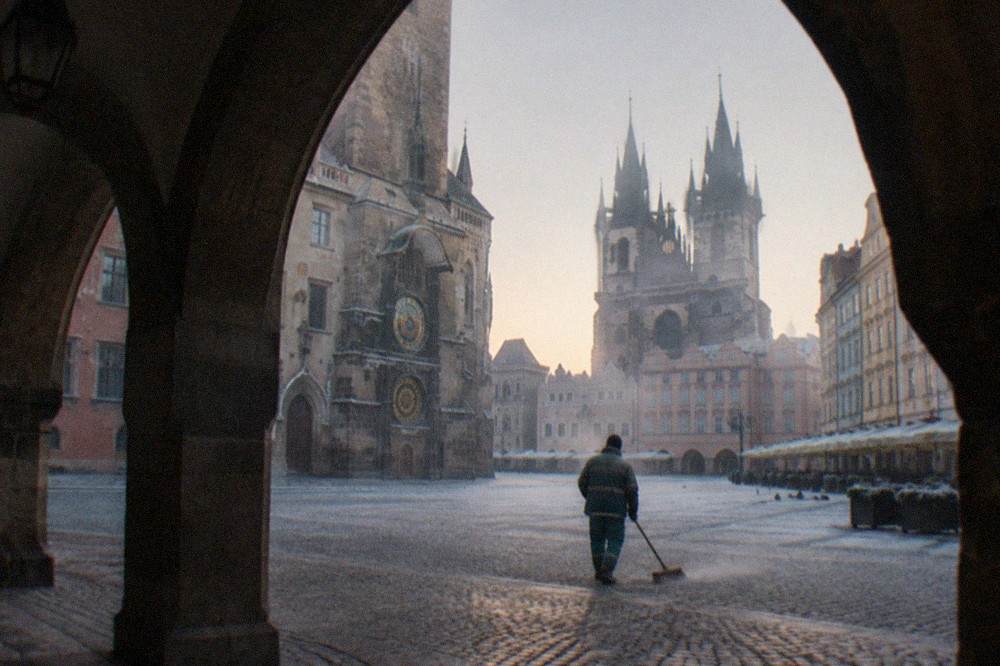 Crowd-free view of Old Town Square with the Astronomical Clock tower and Týn Church spires