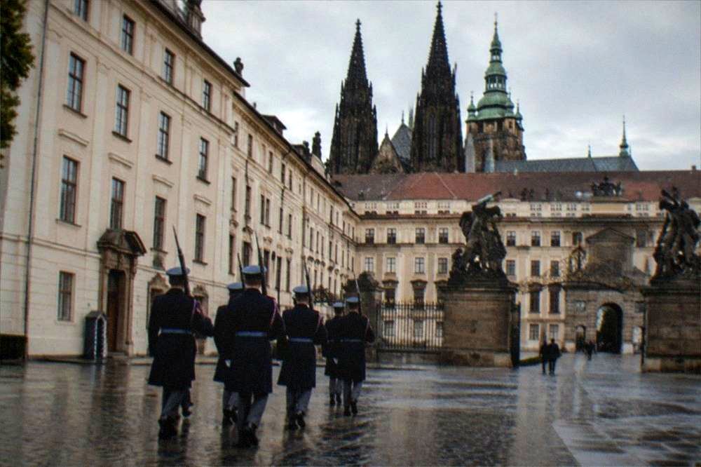 Uniformed castle guards marching in formation across a baroque courtyard