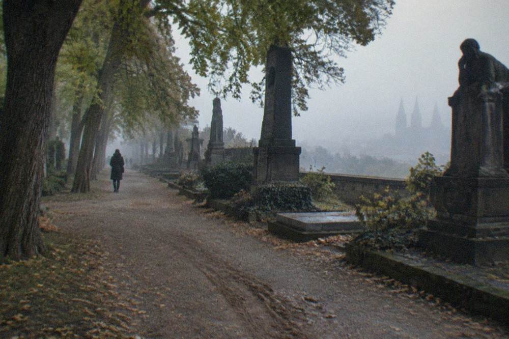 Gravel path through parkland inside the Vyšehrad fortress grounds with mature trees
